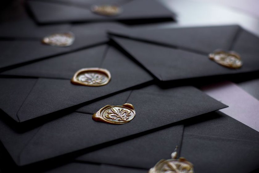 Close-up of a wax wafer seal on an envelope flap